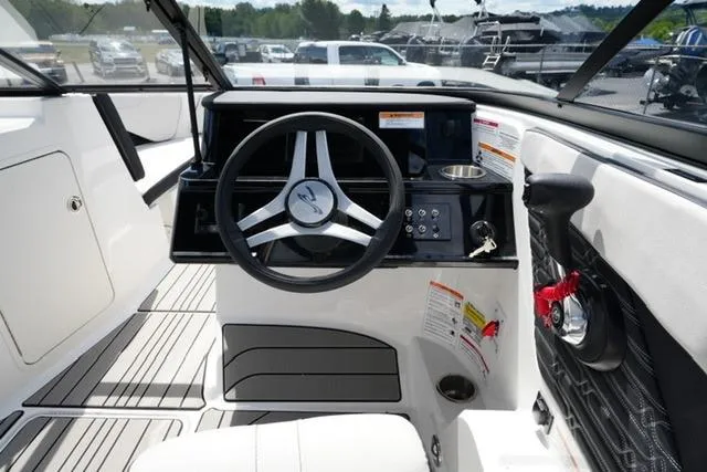 Slide: The Image of 2026 Sea Ray SPX 210 boat cockpit with steering wheel and control panel. - 13