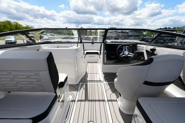 Slide: The Image of Interior of 2026 Sea Ray SPX 210 boat with modern seating and steering wheel. - 14