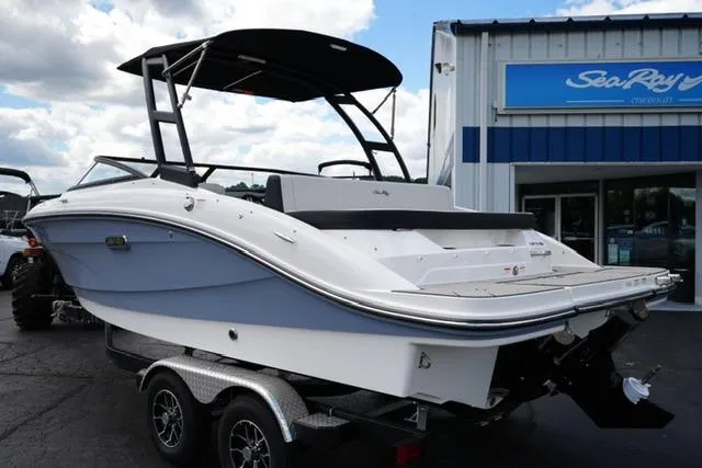 Slide: The Image of 2026 Sea Ray SPX 210 boat on trailer, displayed outside dealership. - 7
