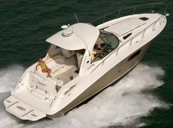 The Image of 2011 Sea Ray 370 Sundancer yacht docked by lush greenery. - 0