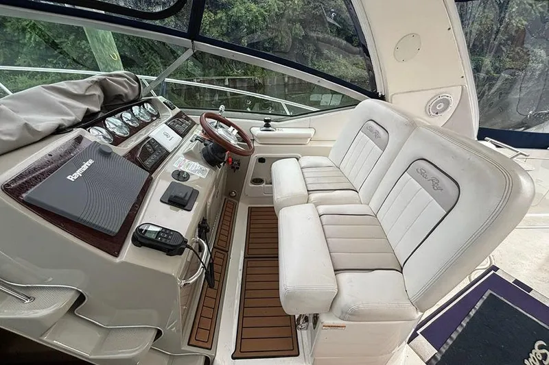 Slide: The Image of Interior of a 2011 Sea Ray 370 Sundancer boat with helm and seating area. - 10