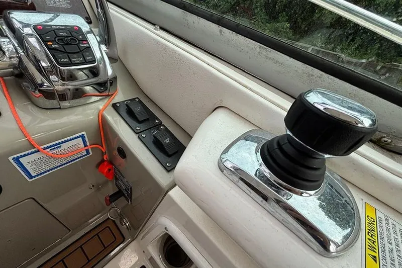 Slide: The Image of Control panel of a 2011 Sea Ray 370 Sundancer boat with joystick and switches. - 12