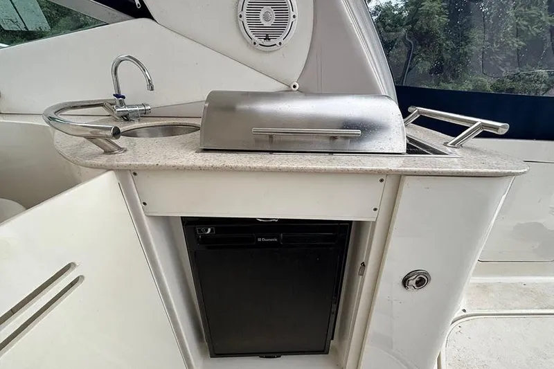 Slide: The Image of Outdoor kitchenette on 2011 Sea Ray 370 Sundancer with sink, grill, and mini fridge. - 15