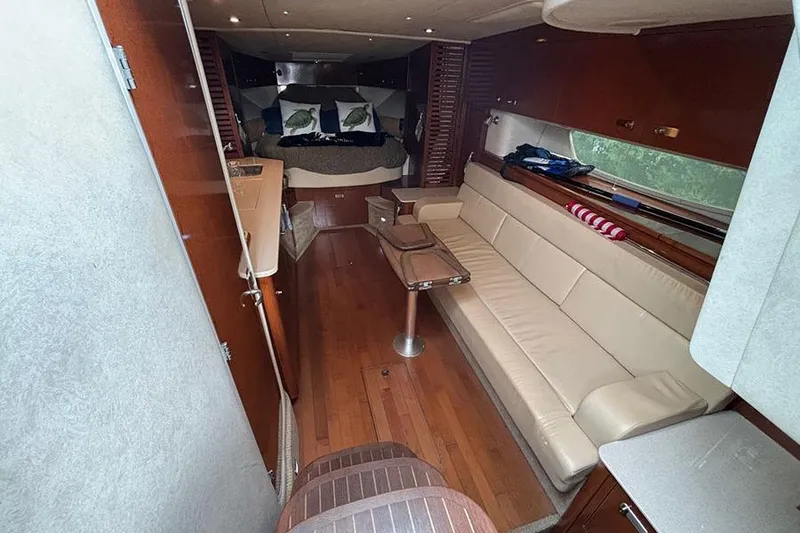 Slide: The Image of Luxurious interior of 2011 Sea Ray 370 Sundancer with leather seating and wooden flooring. - 20