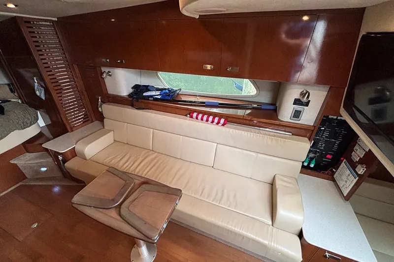 Slide: The Image of Luxurious interior of 2011 Sea Ray 370 Sundancer yacht with leather seating and wooden finishes. - 21