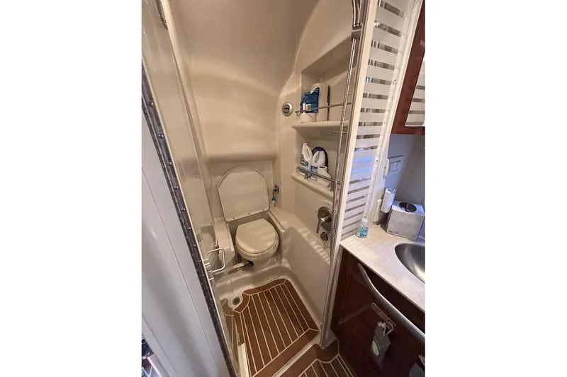 Slide: The Image of Bathroom interior of 2011 Sea Ray 370 Sundancer yacht, featuring compact design and amenities. - 24