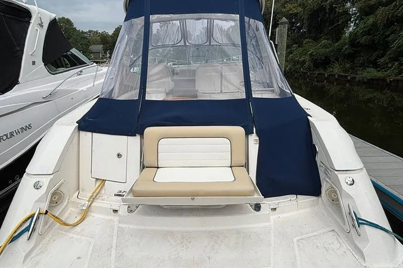 Slide: The Image of 2011 Sea Ray 370 Sundancer boat docked, featuring a covered seating area. - 3