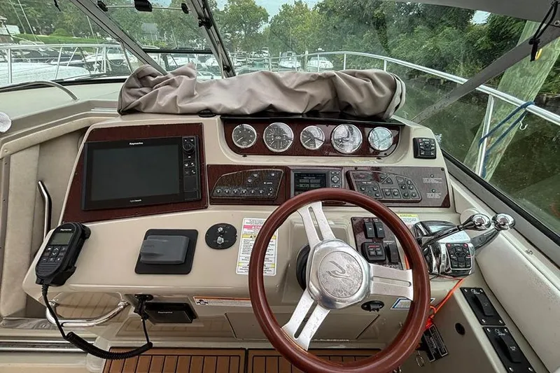 Slide: The Image of Helm of 2011 Sea Ray 370 Sundancer with steering wheel and navigation controls. - 4