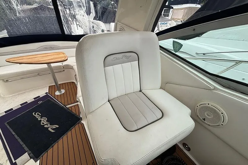 Slide: The Image of Interior of 2011 Sea Ray 370 Sundancer with white seating and wooden table. - 9
