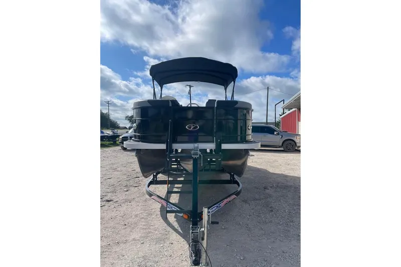 Slide: The Image of 2024 Veranda Relax VR22RC pontoon boat on trailer under blue sky. - 2