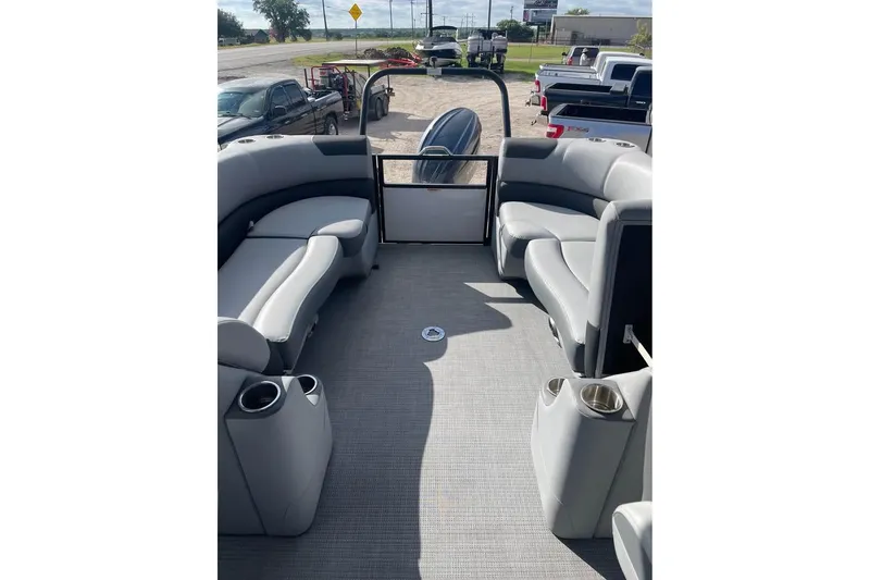 Slide: The Image of 2024 Veranda Relax VR22RC pontoon boat interior with gray seating and cup holders. - 7