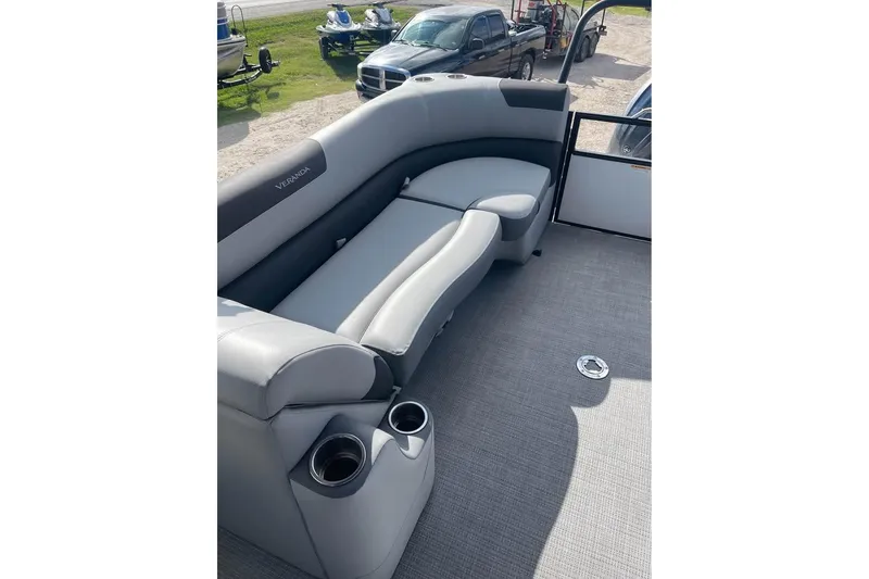 Slide: The Image of 2024 Veranda Relax VR22RC pontoon boat interior with gray seating and cup holders. - 8