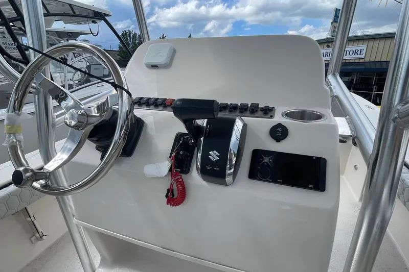 Slide: The Image of 2026 Carolina Skiff 22 Ultra Elite boat console with steering wheel and controls. - 10