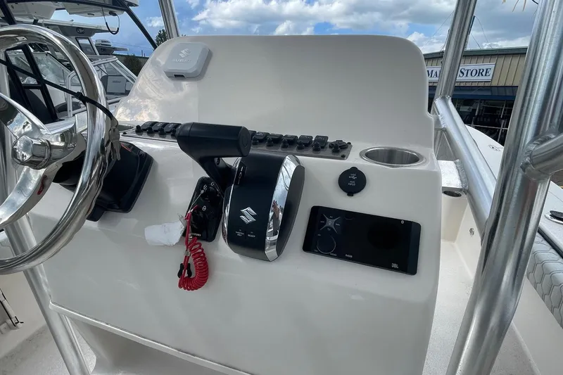 Slide: The Image of 2026 Carolina Skiff 22 Ultra Elite boat console with steering wheel and controls. - 11
