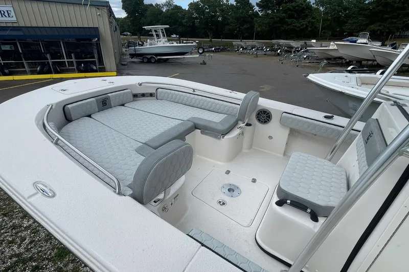 Slide: The Image of 2026 Carolina Skiff 22 Ultra Elite boat interior with gray seating and spacious layout. - 12