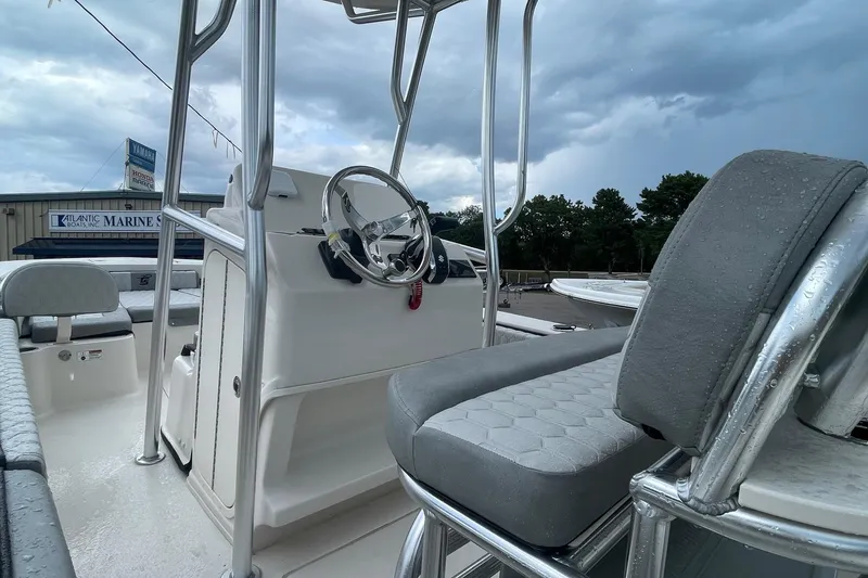 Slide: The Image of 2026 Carolina Skiff 22 Ultra Elite boat interior with steering wheel and seating. - 13