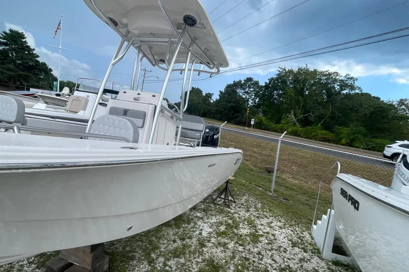 Slide: The Image of 2026 Carolina Skiff 22 Ultra Elite boat displayed outdoors, showcasing sleek design and modern features. - 3