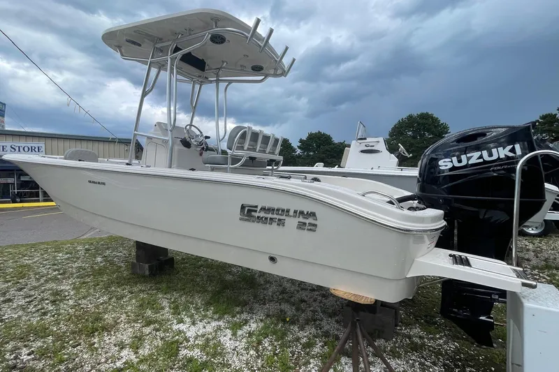 Slide: The Image of 2026 Carolina Skiff 22 Ultra Elite boat with Suzuki engine displayed outdoors. - 4