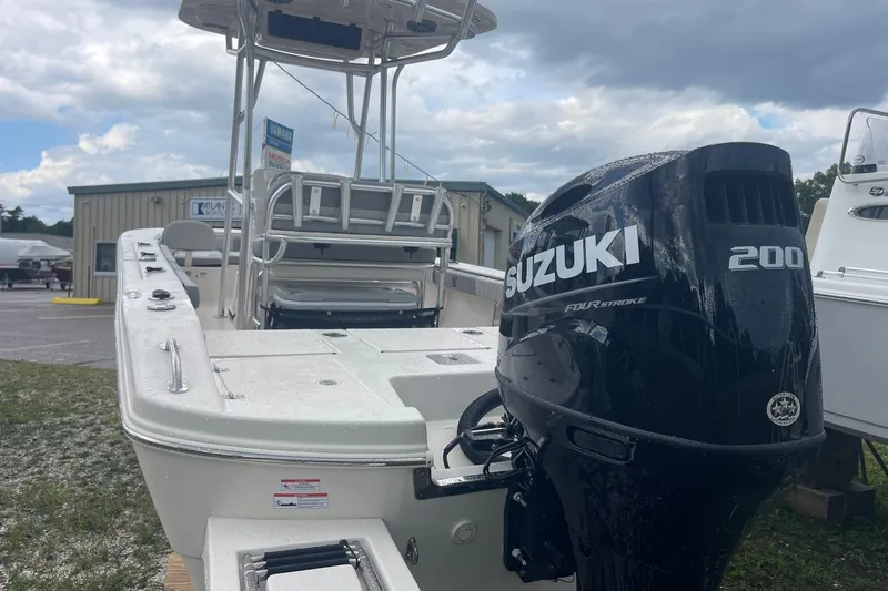Slide: The Image of 2026 Carolina Skiff 22 Ultra Elite boat with Suzuki 200 engine, parked outdoors. - 6
