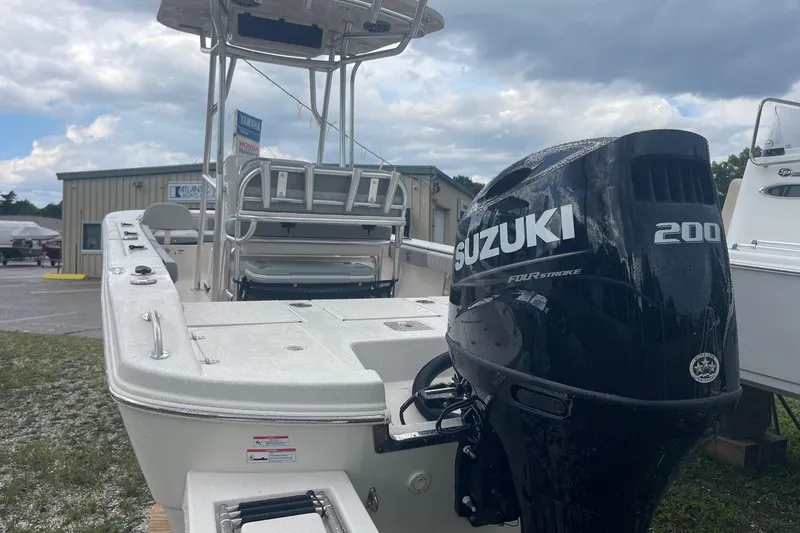 Slide: The Image of 2026 Carolina Skiff 22 Ultra Elite boat with Suzuki 200 engine, parked outdoors. - 7