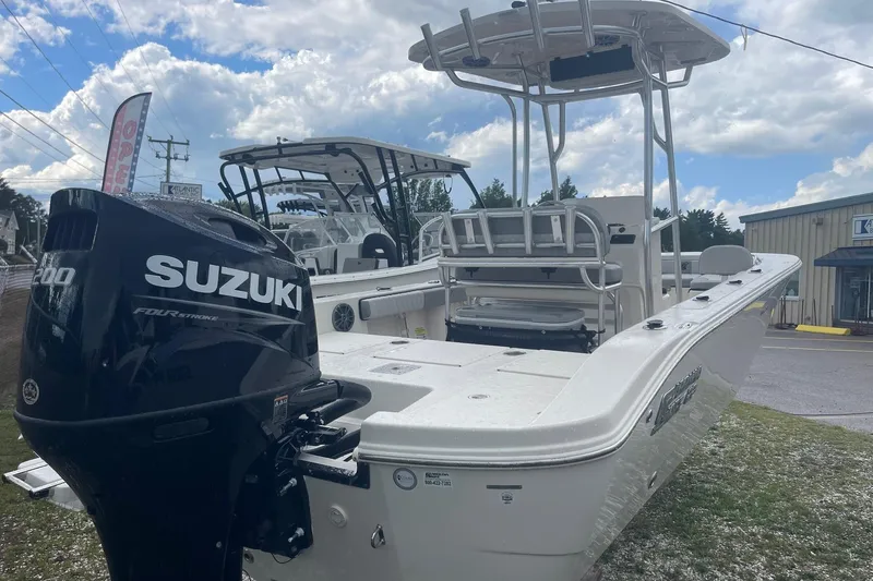 Slide: The Image of 2026 Carolina Skiff 22 Ultra Elite boat with Suzuki engine, parked outdoors. - 8
