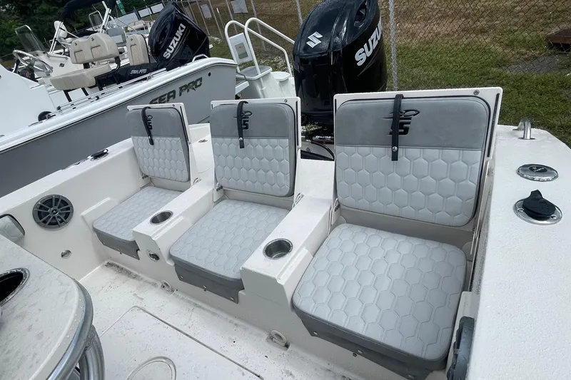 Slide: The Image of 2026 Carolina Skiff 22 Ultra Elite boat seats with hexagonal pattern and cup holders. - 9