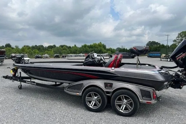 The Image of 2024 Ranger Z521R bass boat on trailer, parked outdoors under cloudy sky. - 1