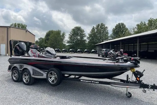 Slide: The Image of 2024 Ranger Z521R boat on trailer, parked outdoors under cloudy sky. - 3