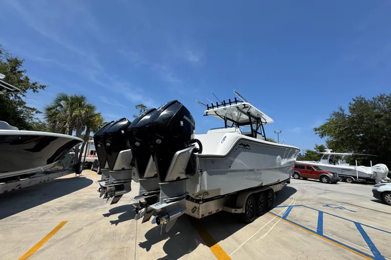 Slide: The Image of 2021 Invincible 35' Catamaran with Mercury engine on trailer, parked outdoors. - 12