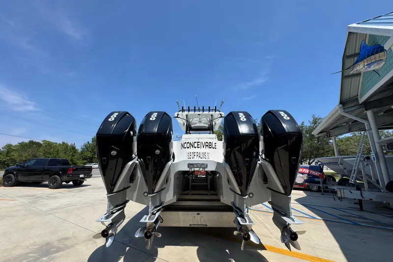 Slide: The Image of 2021 Invincible 35' Catamaran with four powerful outboard engines, parked outdoors. - 14