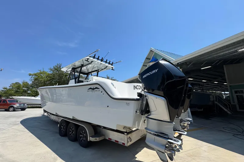 Slide: The Image of 2021 Invincible 35' Catamaran with Mercury engines on a trailer, parked outdoors. - 16