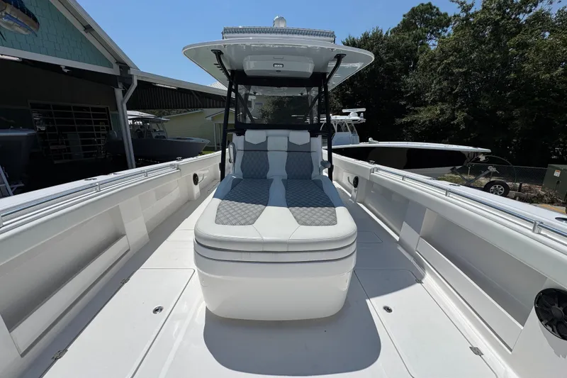 Slide: The Image of 2021 Invincible 35' Catamaran with sleek seating and modern design in a marina setting. - 19