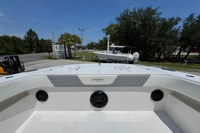 Slide: The Image of 2021 Invincible 35' Catamaran with spacious seating and sleek design in a marina setting. - 21