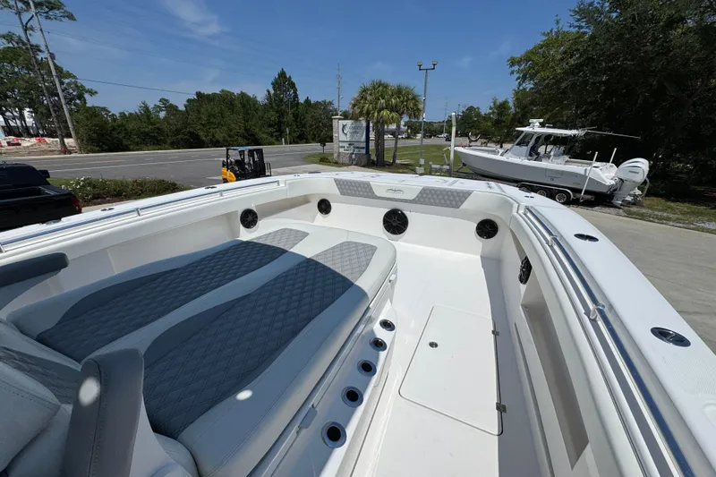 Slide: The Image of 2021 Invincible 35' Catamaran with spacious seating and sleek design in a marina setting. - 22
