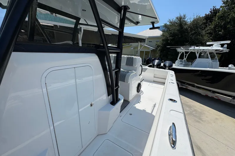 Slide: The Image of 2021 Invincible 35' Catamaran, sleek design, docked with another boat in the background. - 23