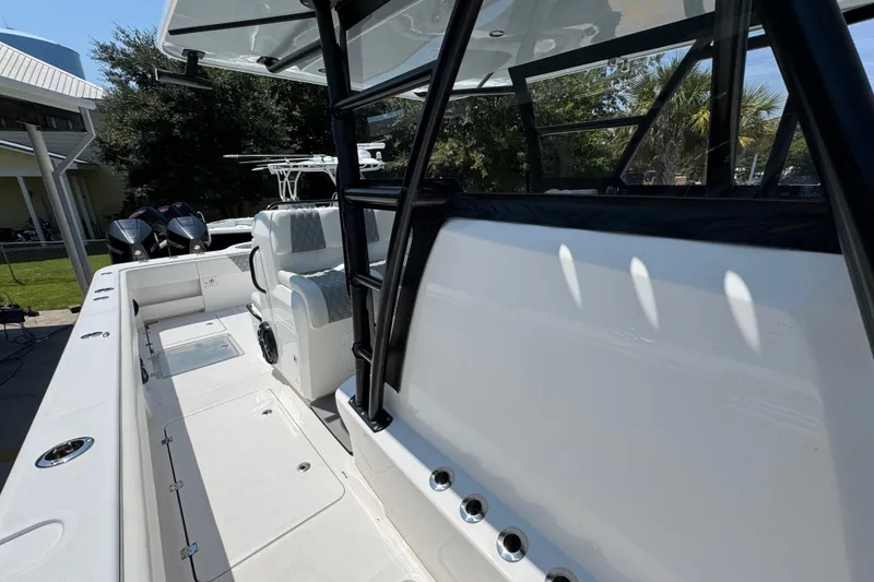 Slide: The Image of 2021 Invincible 35' Catamaran with sleek design and spacious seating, docked near other boats. - 24
