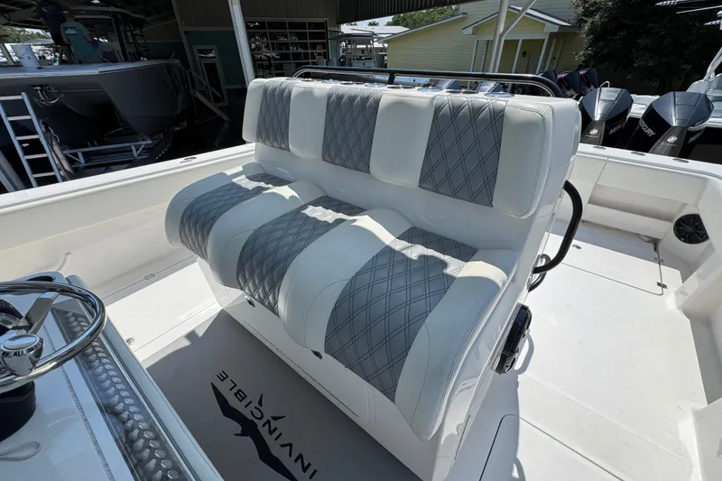Slide: The Image of Interior of 2021 Invincible 35' Catamaran featuring a compact marine toilet and control panel. - 25