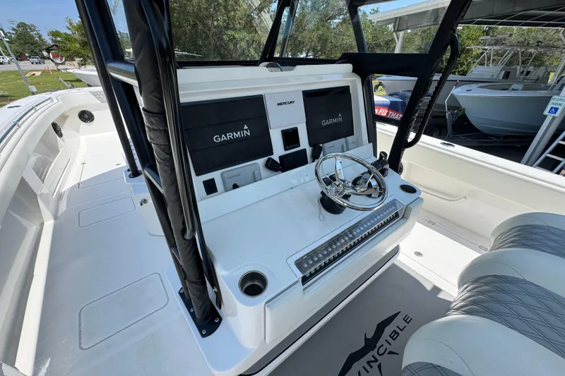 Slide: The Image of 2021 Invincible 35' Catamaran with dual Mercury engines, docked near other boats. - 28