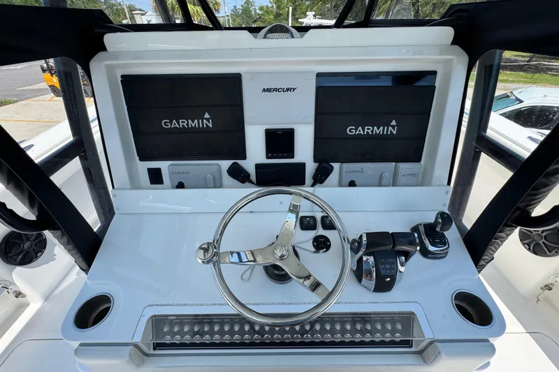 Slide: The Image of 2021 Invincible 35' Catamaran helm with Garmin navigation and Mercury controls. - 29