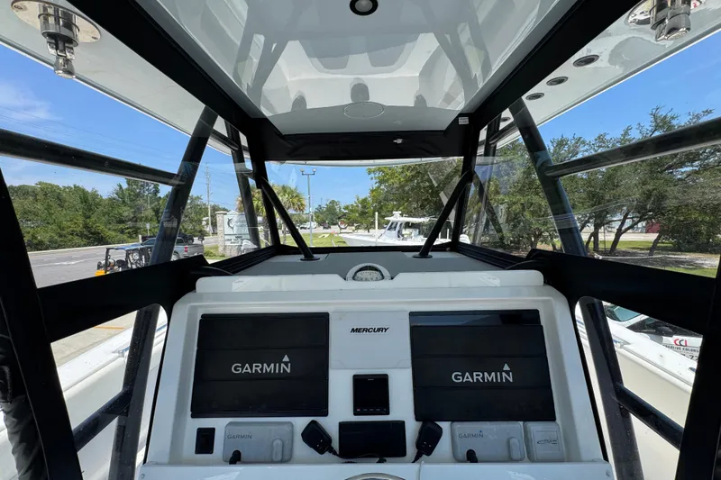 Slide: The Image of Helm of 2021 Invincible 35' Catamaran with Garmin navigation and Mercury controls. - 30