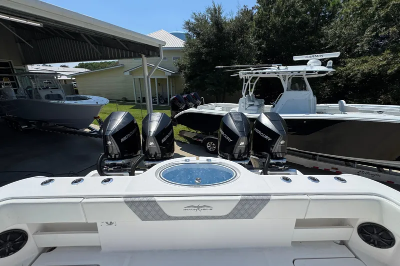 Slide: The Image of 2021 Invincible 35' Catamaran with seating and rod holders, docked at a marina. - 35