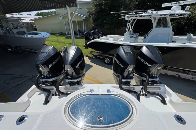 Slide: The Image of 2021 Invincible 35' Catamaran with cushioned seating and fishing rod holders, parked outdoors. - 36