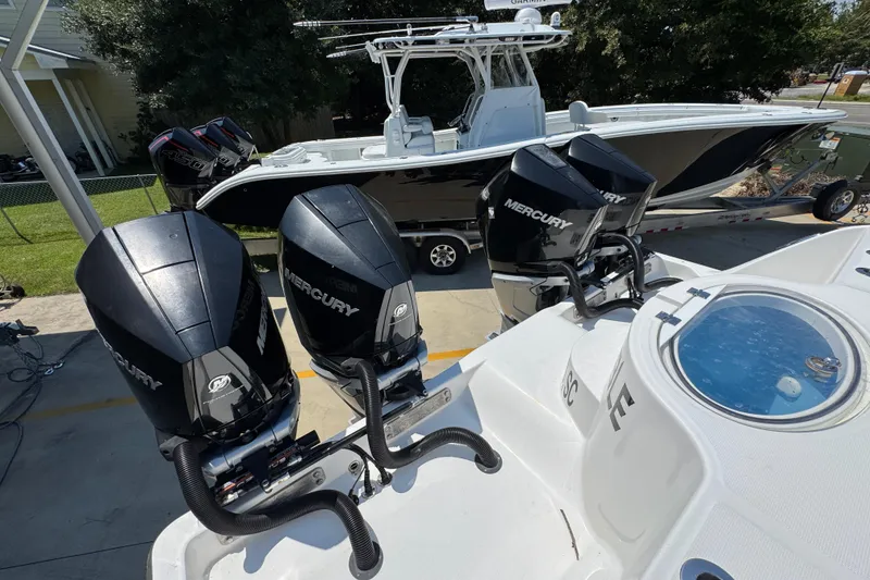 Slide: The Image of 2021 Invincible 35' Catamaran with multiple outboard engines in a boatyard setting. - 38