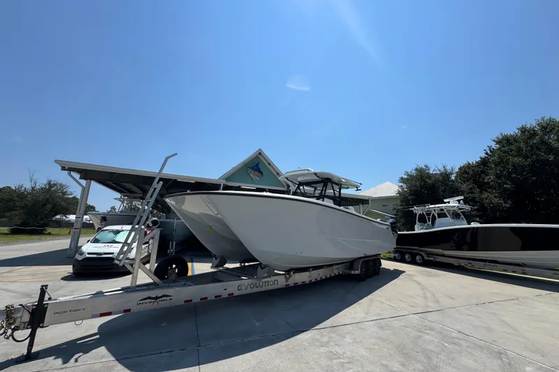 Slide: The Image of 2021 Invincible 35' Catamaran on trailer under cloudy sky. - 4