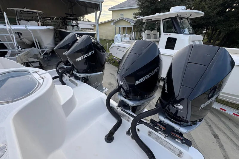 Slide: The Image of 2021 Invincible 35' Catamaran with four Mercury outboard engines, docked in a marina. - 40