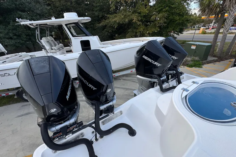 Slide: The Image of 2021 Invincible 35' Catamaran with triple Mercury outboard engines, parked on a trailer. - 41