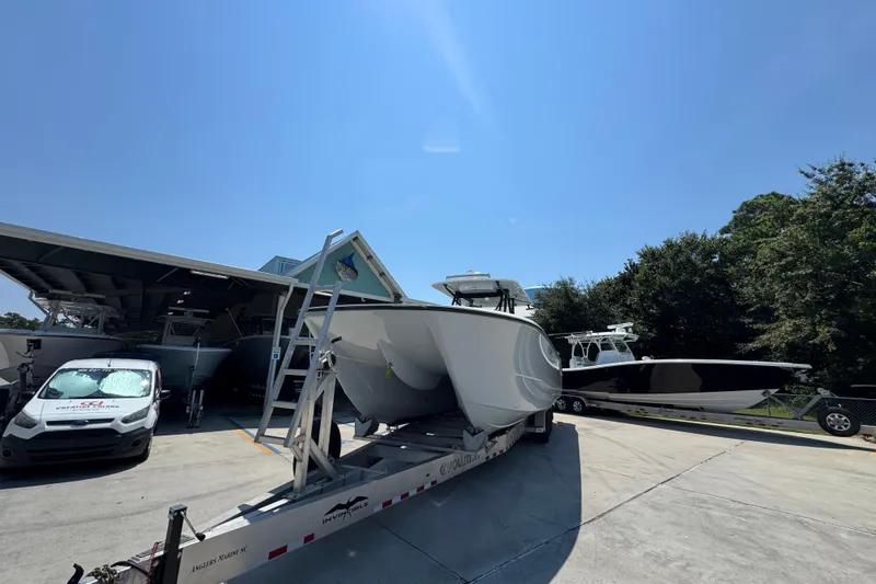 Slide: The Image of 2021 Invincible 35' Catamaran on trailer at marina under cloudy sky. - 5