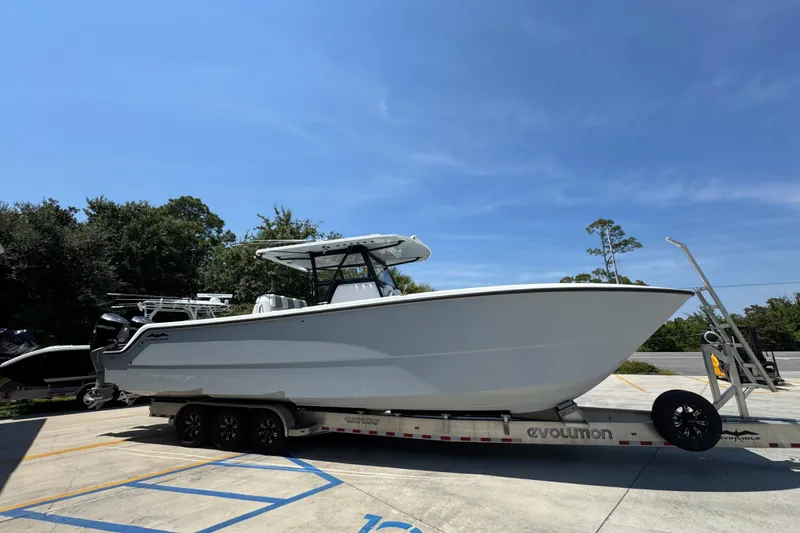 Slide: The Image of 2021 Invincible 35' Catamaran on trailer, parked outdoors under a blue sky. - 9