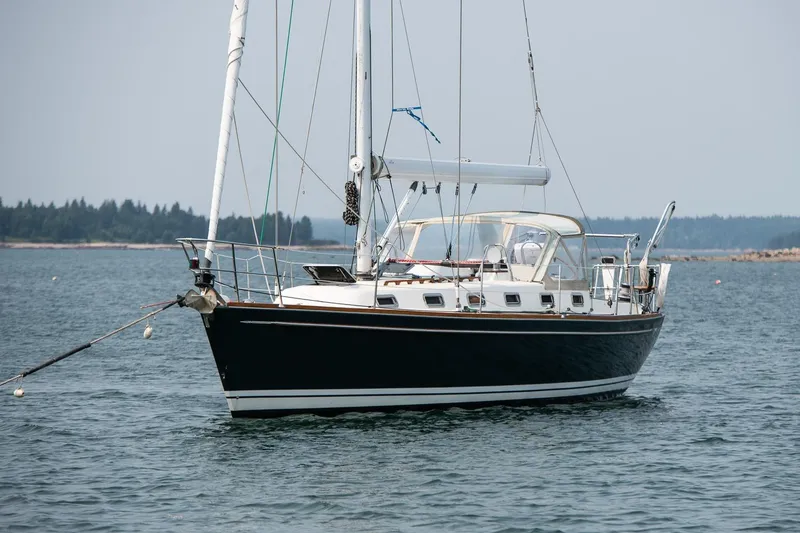 Slide: The Image of Sailboat Tartan 4100 (2002) anchored on calm water with distant shoreline. - 19