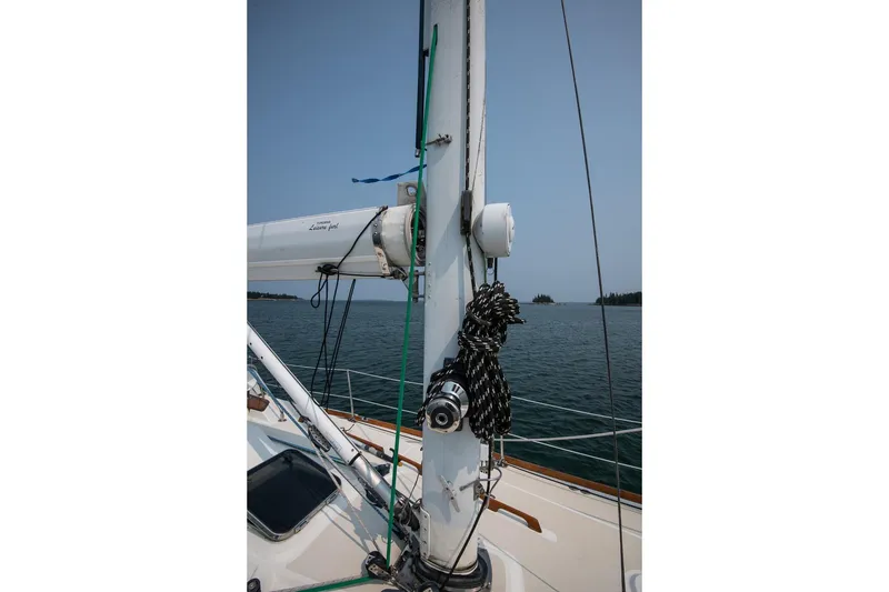 Slide: The Image of Sailboat mast and rigging on a 2002 Tartan 4100, with ocean and island background. - 25